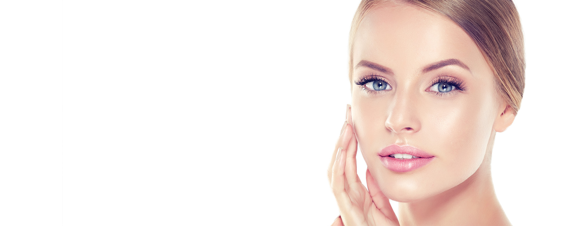 Portrait of young woman with clean fresh skin and soft, delicate make up. Woman is touching tenderly to own face.